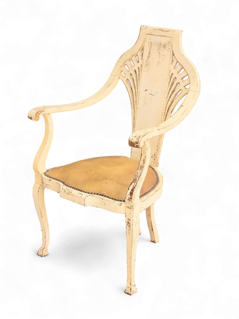 FOLKSY PAINTED ARM CHAIR, FAN BACK: Early 20th century, wood and fabric. A folksy armchair with factory-produced wooden frame and paw-shaped seat upholstered with tacked oilcloth. Old white paint with distressed finish. Chair splat with