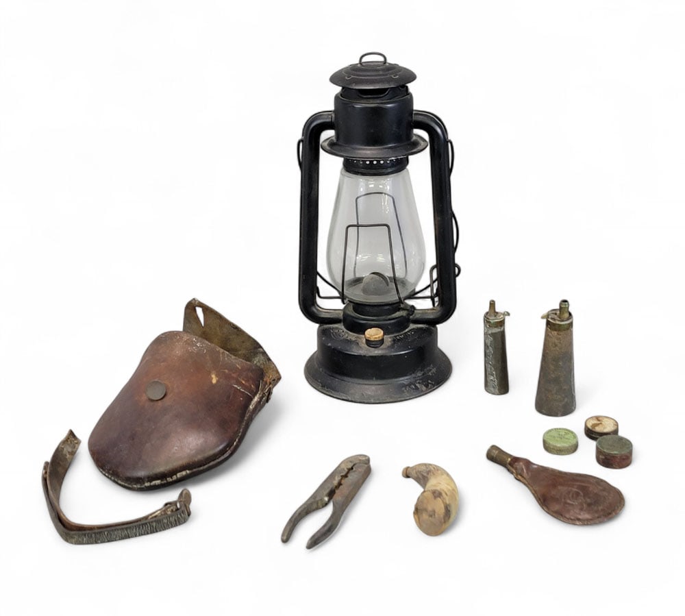 LANTERN AND HUNTING ACCESSORIES: American, 19th century. Includes a Rayo No. 78 kerosene lantern, 16" high; together with a hunting pouch that contains a shot mold, shot pouch, priming cap tins, two priming flasks, and one priming ho