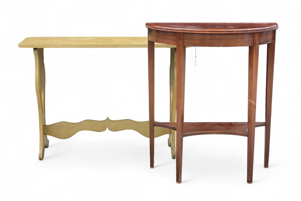 TWO SIDE TABLES: American, 20th century, mixed woods. Two reproduction side tables. A trestle-style sofa table, painted mustard yellow over green. And a demilune console table with mahogany finish, bearing a tag for E
