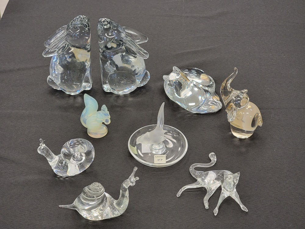 COLLECTION OF GLASS ANIMALS: 20th century. Includes a Baccarat cat, an opalescent Sabino squirrel, a Lalique bird ring dish, a pair of Sylvestri rabbit bookends, a Steuben snail, a Balos elephant, and an unmarked snail and cat. B