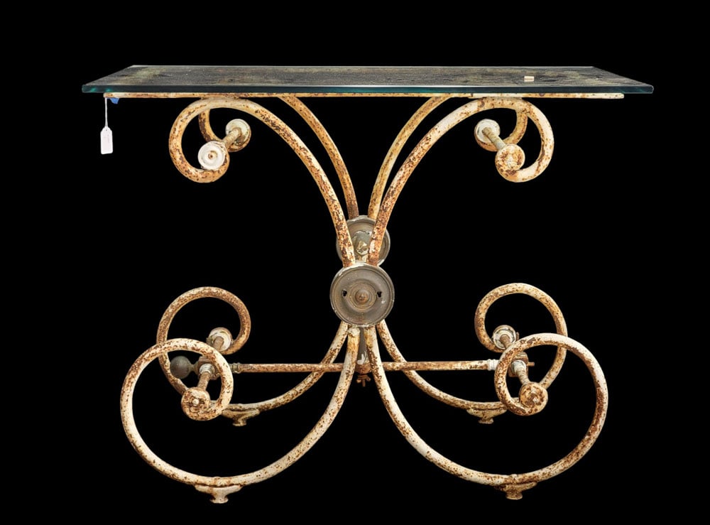 VINTAGE GARDEN TABLE: Mid-20th century, iron. Scrolled base with old white paint, and a glass top. 29" high, 37" wide, 23" deep. Provenance: a northeast Ohio collection. PLEASE NOTE OUR SHIPPING PROCESS. There are four way