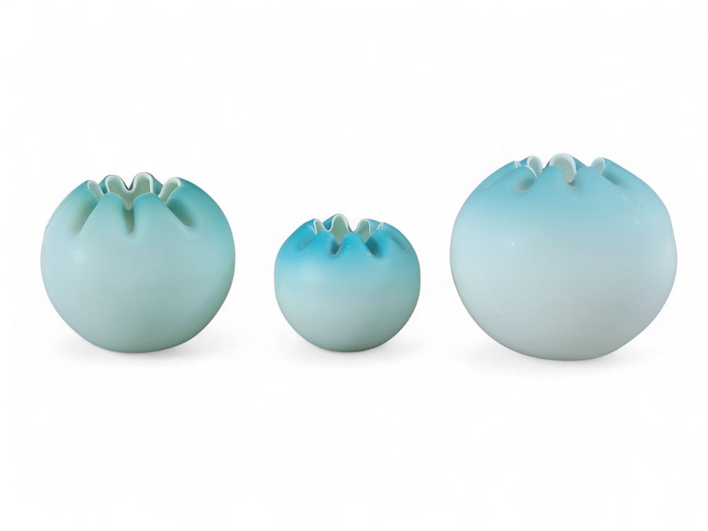 THREE BLUE SATIN GLASS ROSE BOWLS: American, late 19th or early 20th century, blown glass. Three satin glass rose bowls in blue shades (different makers). Spherical cased bodies with white underlayers and eight crimps at rims, pontil s