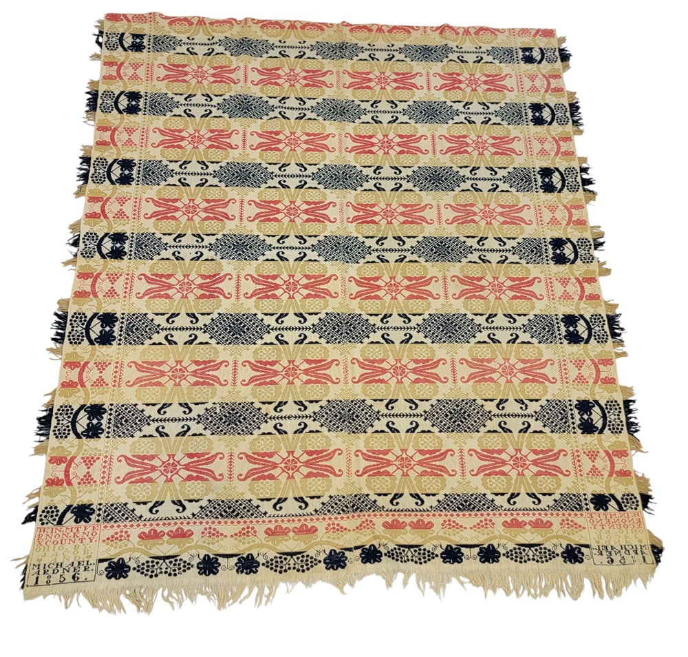 OHIO JACQUARD COVERLET, ARDNER BROTHERS 1856: Knox Co., Ohio, 1856. A jacquard coverlet in red, gold, blue, and white with a tiled centerfield containing four flowers with curling leaves resembling "pincers," offset with concentric diamonds. Grap