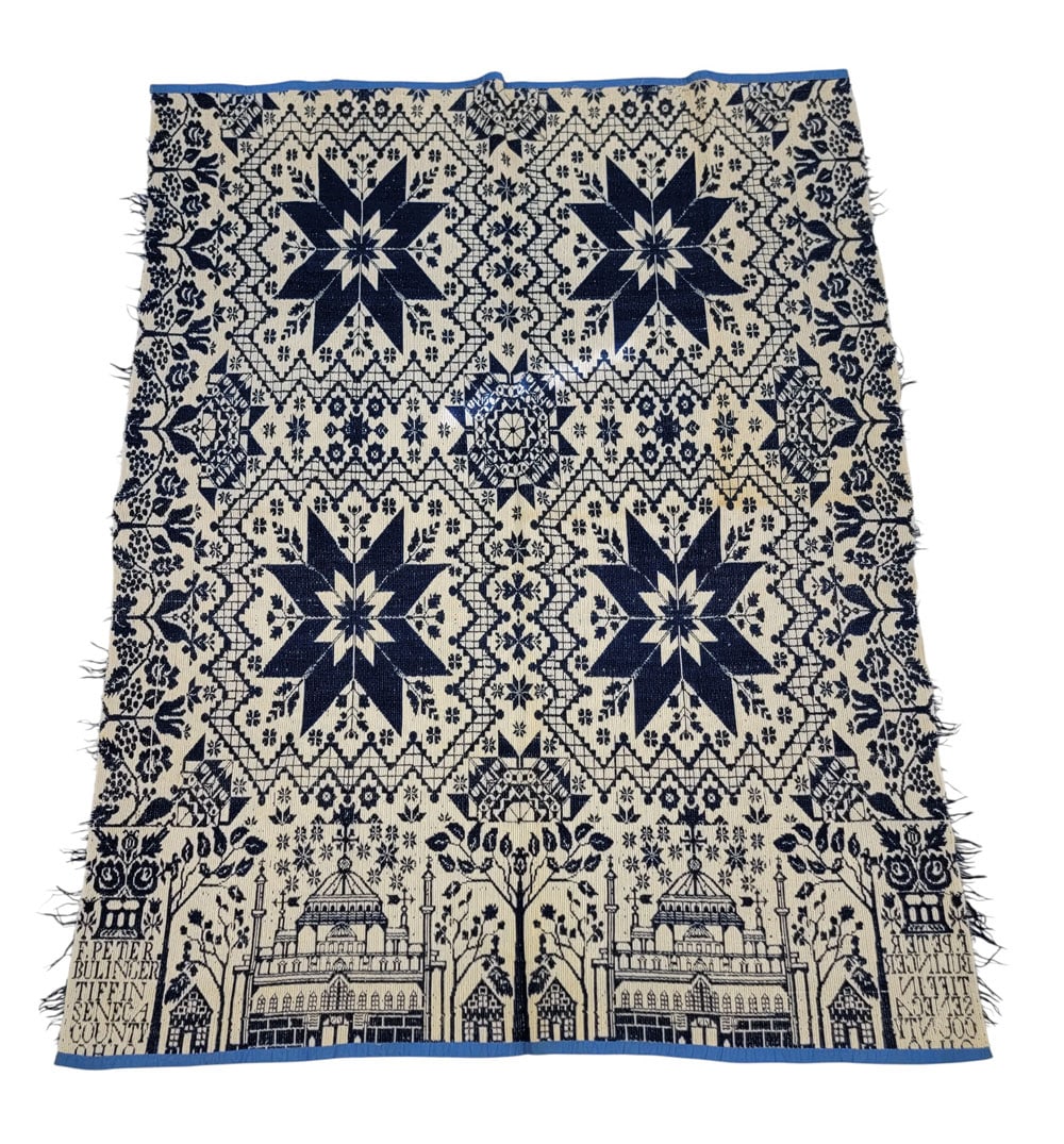 OHIO JACQUARD COVERLET, SIGNED W/ UNUSUAL BORDER: Seneca Co., Ohio, mid-19th century. A jacquard coverlet in blue and white. Centerfield with large 8-point stars in geometric tiles, surrounded by small blossoms. Side borders with tulips and grape vin