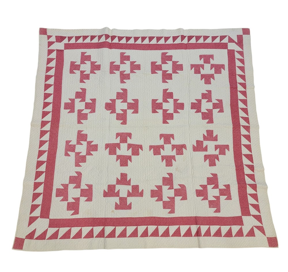 UNUSUAL PATCHWORK QUILT: American, 19th century, cotton. A patchwork quilt with kimoni or T blocks, patterned pink fabric on solid white with a sawtooth border. Hand-pieced and quilted. 72" long, 70" wide. Provenance: The Col