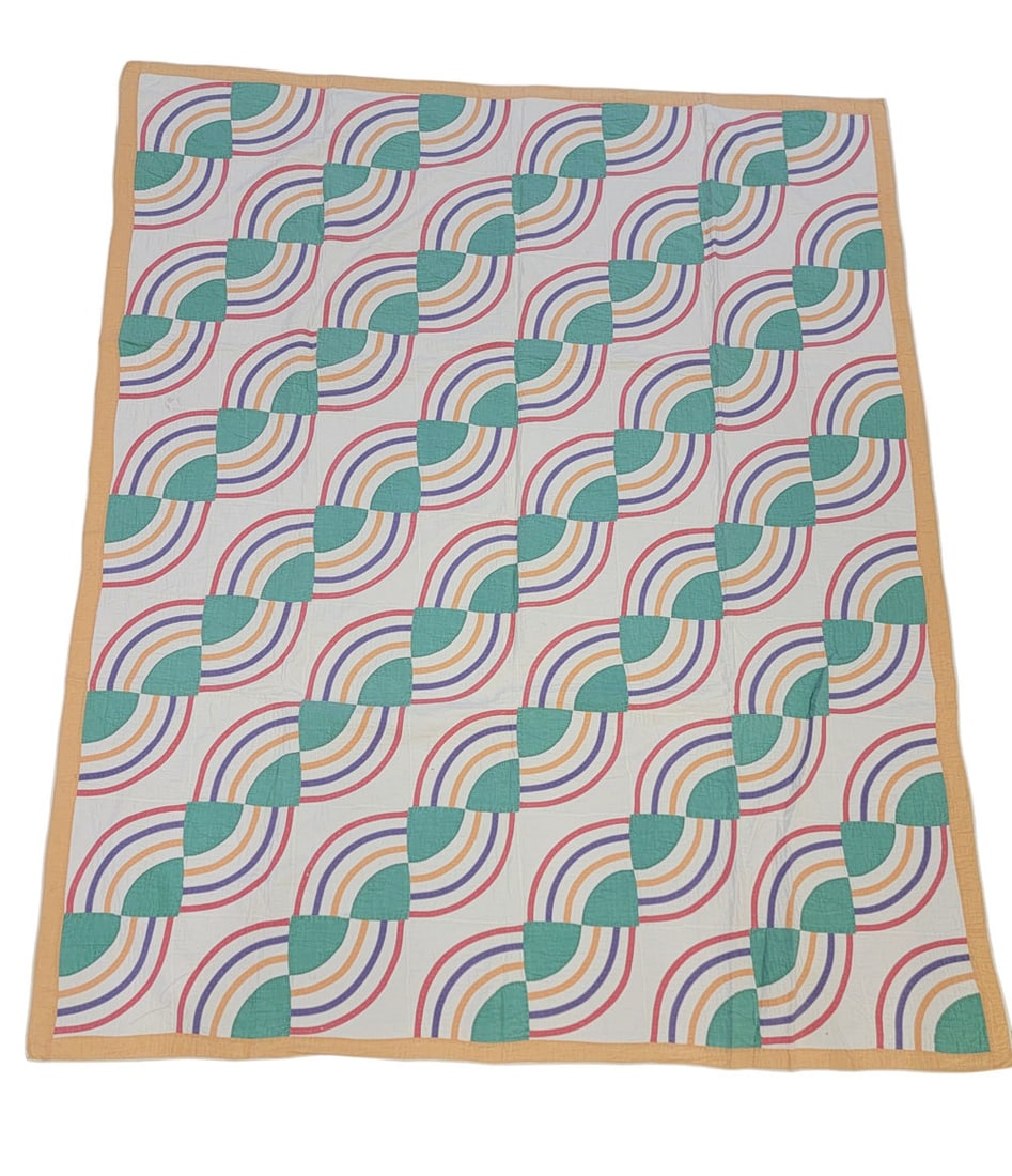 FAN/CHAIN APPLIQUE QUILT: American, mid 20th century, cotton. A pieced and applique quilt in McCall's fan or chain pattern from 1931-42, composed of solid green, pink, purple, and orange fabrics on a solid white ground. Machin