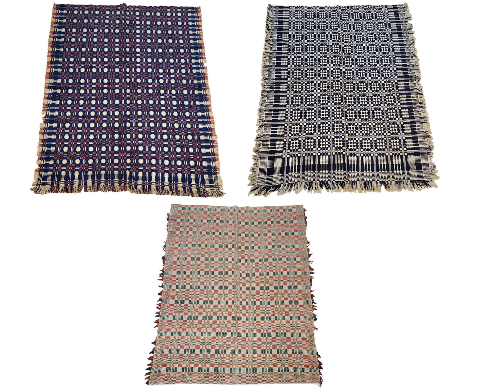 OVERSHOT COVERLETS, GROUP OF THREE: American, 19th century, wool. Three overshot coverlets: the first in red, white, and indigo. Centerfield with snowballs and rosettes. Border with pine trees. With center seam, and fringed on three sid