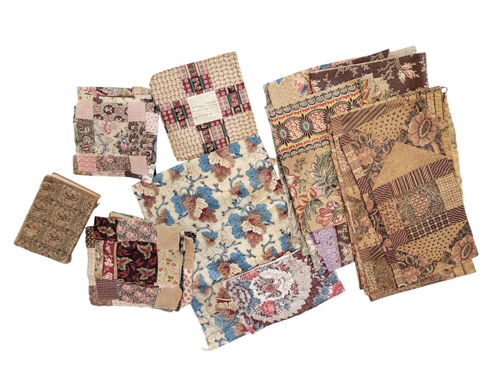 COLLECTION OF EARLY 19TH C. QUILT BLOCKS AND MISC FABRIC: American, early 19th century, cotton. Box of fabric, including calico, several quilt blocks, signed blocks, samples, and a fabric-covered algebra quilt published in 1835 (with an inscription related t