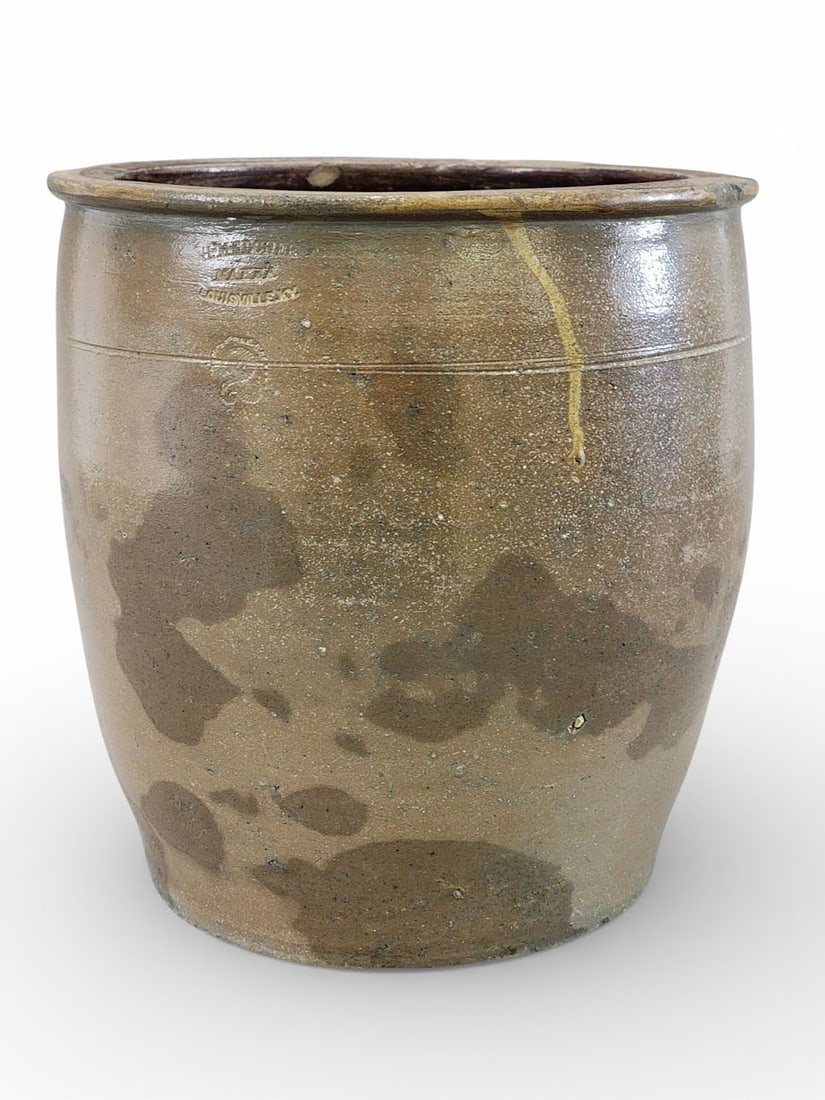 KENTUCKY STONEWARE CROCK: Marked for Henry Melcher, Louisville, c. 1865. Two-gallon crock with impressed stamp. 10" high. Henry Melcher was the brother of potter Anton Melcher. Following Anton's death in 1854, his wife, Cather