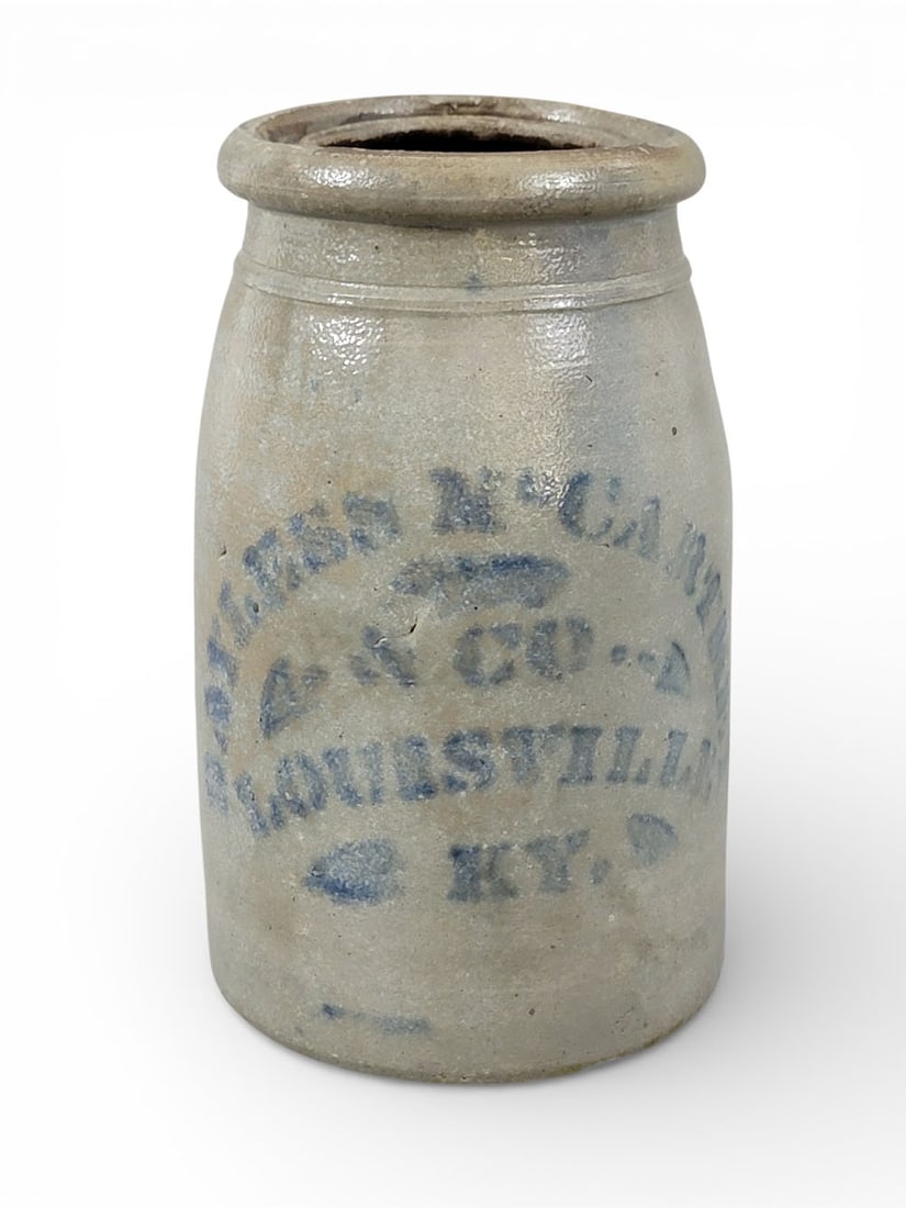 KENTUCKY STONEWARE CANNING JAR: Southwestern Pennsylvania, c. 1875, retailed by Bayless and McCarthey, Louisville. Wax sealer with cobalt stenciled decoration, including stripes. 8.25" high. Provenance: the collection of the late Dr