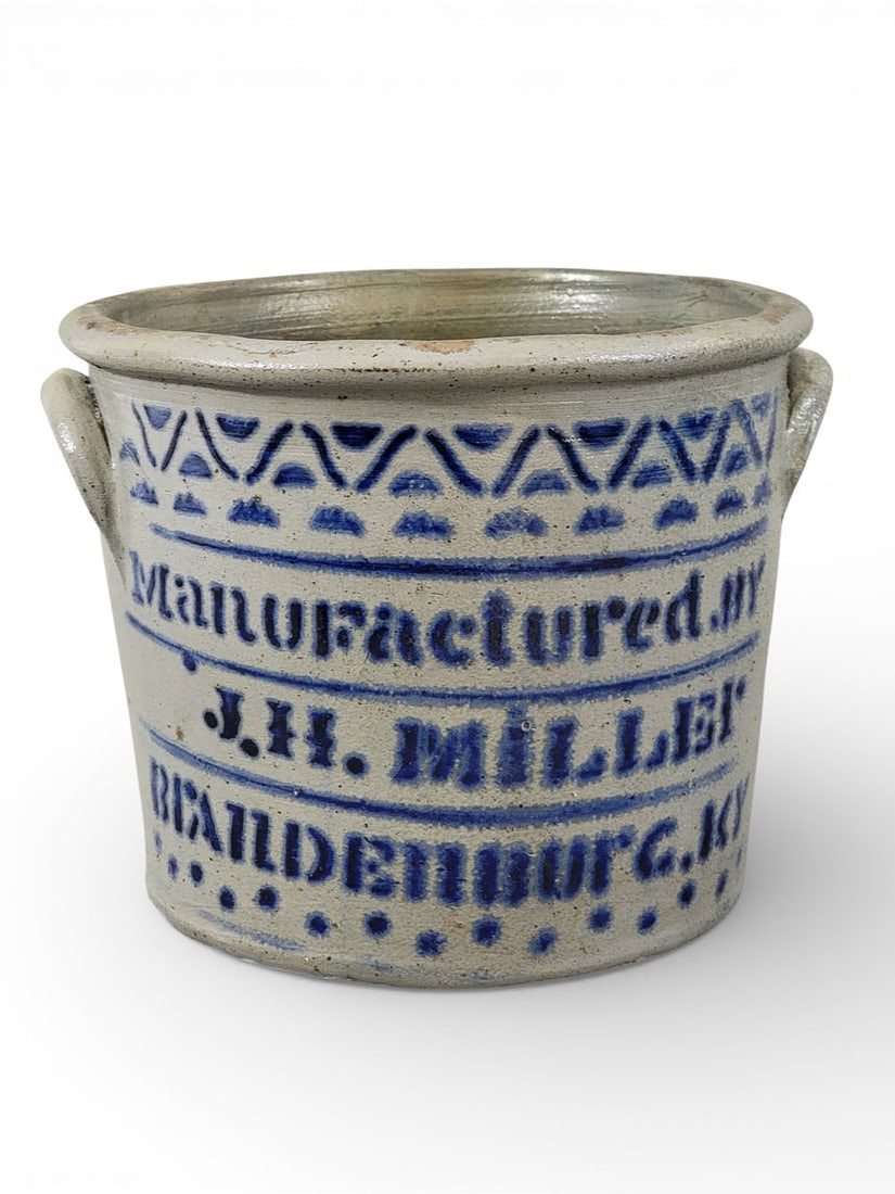 J.H. MILLER KENTUCKY STONEWARE CROCK: James H. Miller (1814-1896, Brandenburg. Cylindrical two-gallon crock with large and bold stenciled "Manufactured by JH MILLER BRANDENBURG KY." 8.5" high. Miller was born in Shenandoah County, Virgini
