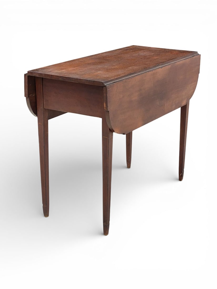 HEPPLEWHITE DROP-LEAF TABLE: American, early 19th century, cherry. A Hepplewhite-style drop-leaf table with inlaid legs and shaped leaves. Springfield, Massachusettes furniture warehouse label on underside. 27.5" tall, 36" wide,