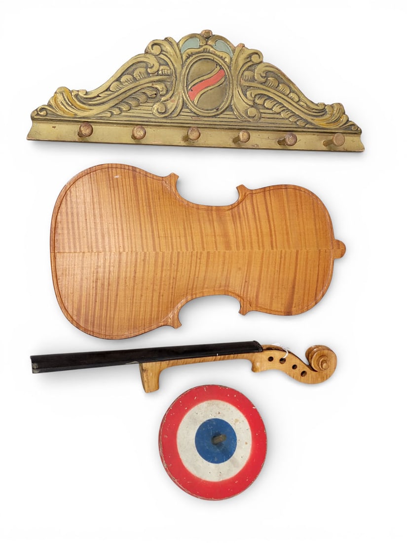 THREE CARVED WOODEN ITEMS: American, 19th century, mixed woods. Three carved items: a tiger maple violin back and neck; a peg rack with a fancy crest; and a red/white/blue painted top. Violin back 14.75" long, 8.25" wide. Prove