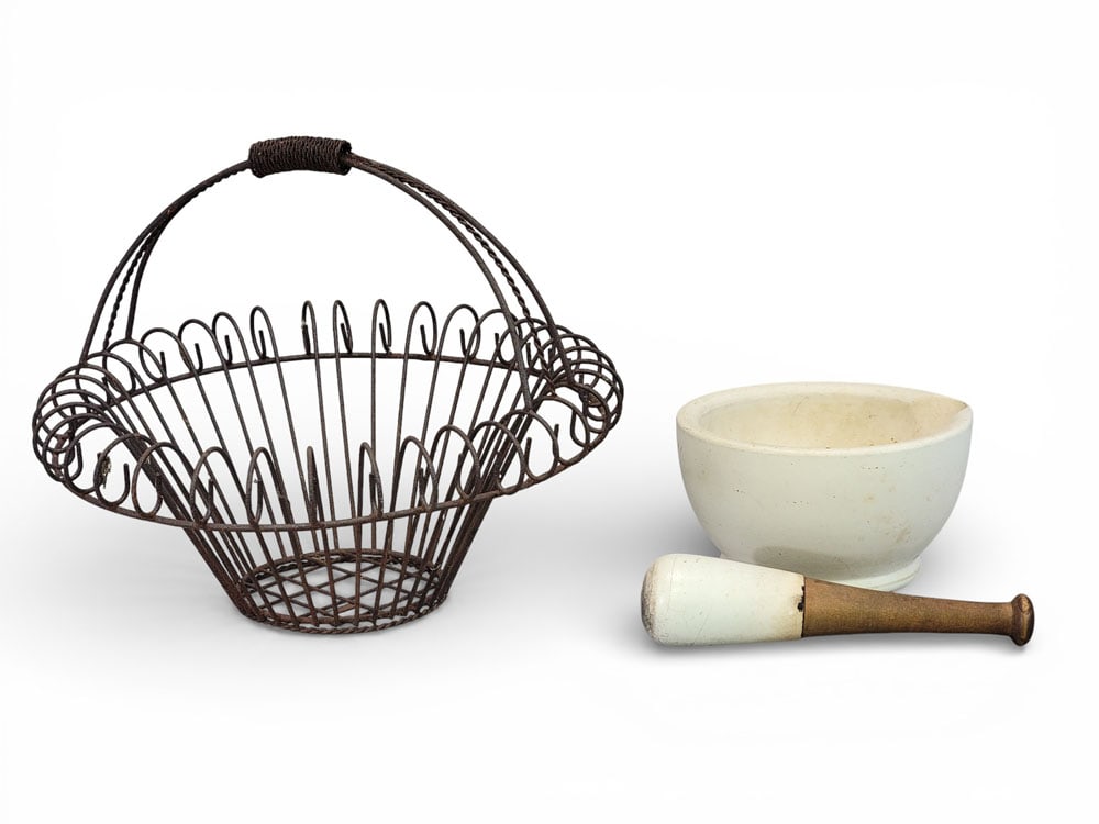 IRON BASKET AND MARBLE MORTAR AND PESTLE: Early 20th century. A wrought iron garden basket and a marble mortar and pestle. Basket 16" high, 19.5" diameter. Provenance: Kemp estate, Belpre, Ohio. NOTE: We are happy to answer questions and take