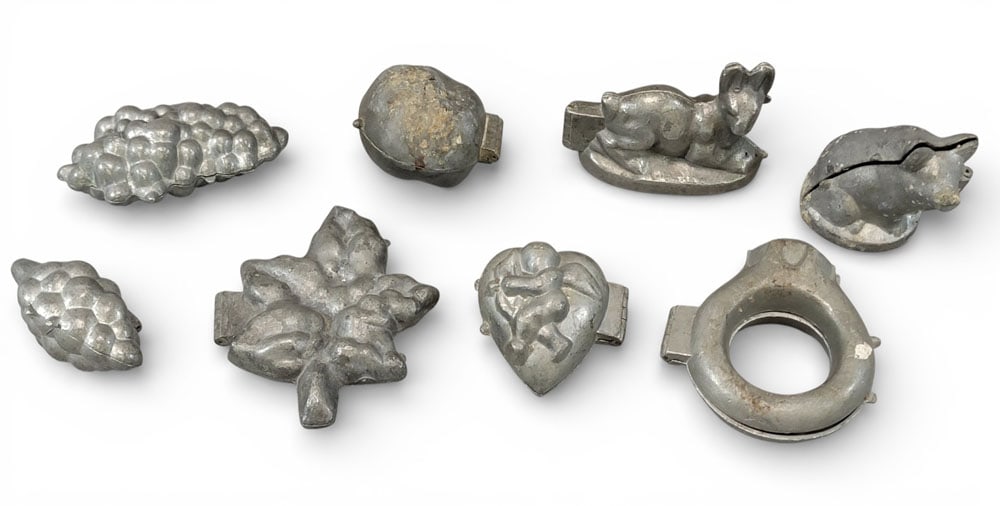 EIGHT CHOCOLATE OR ICE CREAM MOLDS: Late 19th or early 20th century, pewter. Eight chocolate or ice cream molds in animal, fruit, and romantic shapes. Largest 5.75" long. Provenance: Kemp estate, Belpre, Ohio. NOTE: We are happy to answ