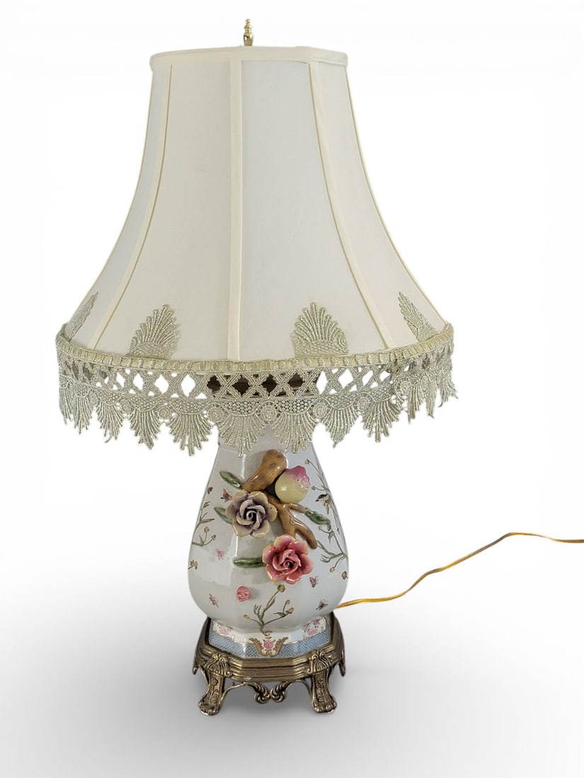 CHINESE-STYLE PAINTED CERAMIC LAMP: 20th century, earthenware, brass, and fabric. A Chinese-style lamp with a vase-like body painted with birds, butterflies, and flowers, mounted on a brass base. Sides adorned with sculpted and painted