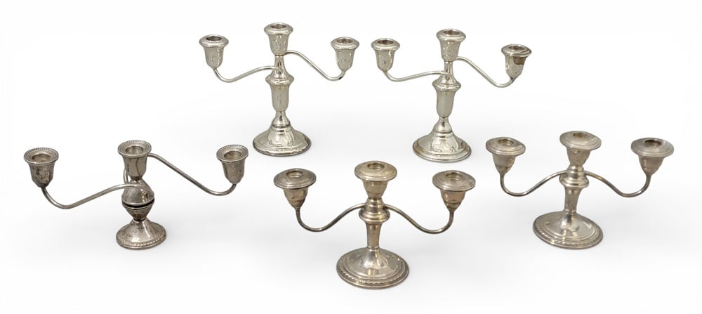 COLLECTION OF WEIGHTED STERLING SILVER CANDLESTICKS: Collection of weighted sterling candlesticks, inc. Duchin, Lord Silver, and Schweitzer. Seven 3-light candelabra and a single candlestick. Tallest 10." Provenance: an Ohio collection. NOTE: We are hap