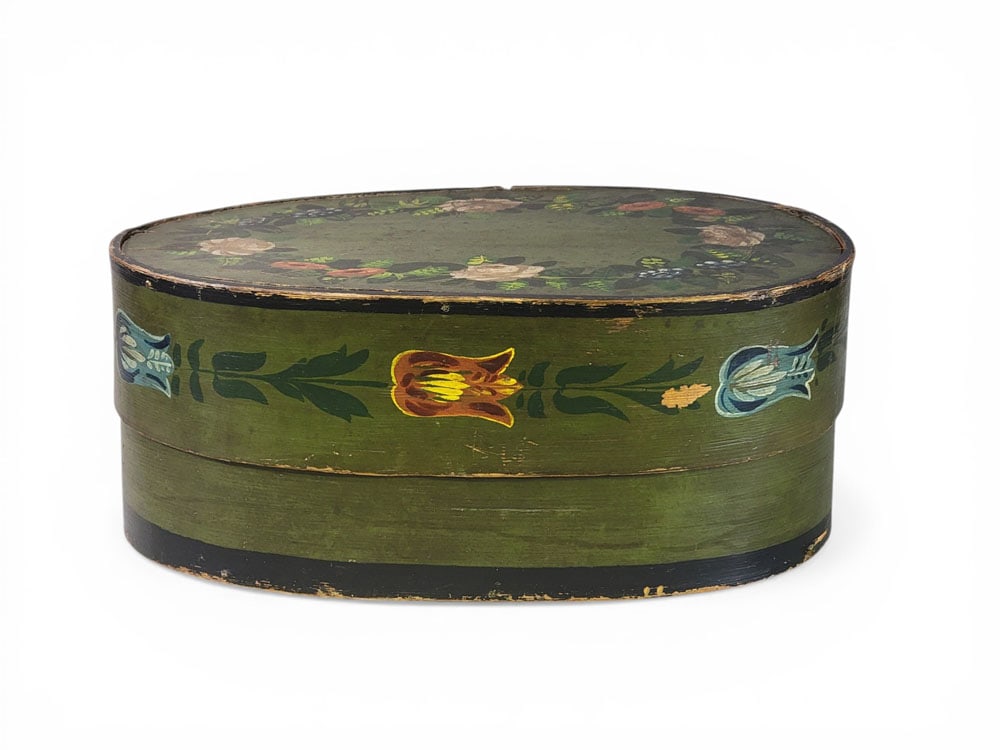 DECORATED BRIDE'S BOX: Northern Europe, 19th century, bentwood. Floral decoration on green ground. 7.5" high, 12.5" wide, 18.5" long. Provenance: Collection of Bob and Maxine Edwards, New Philadelphia, Ohio NOTE: We are