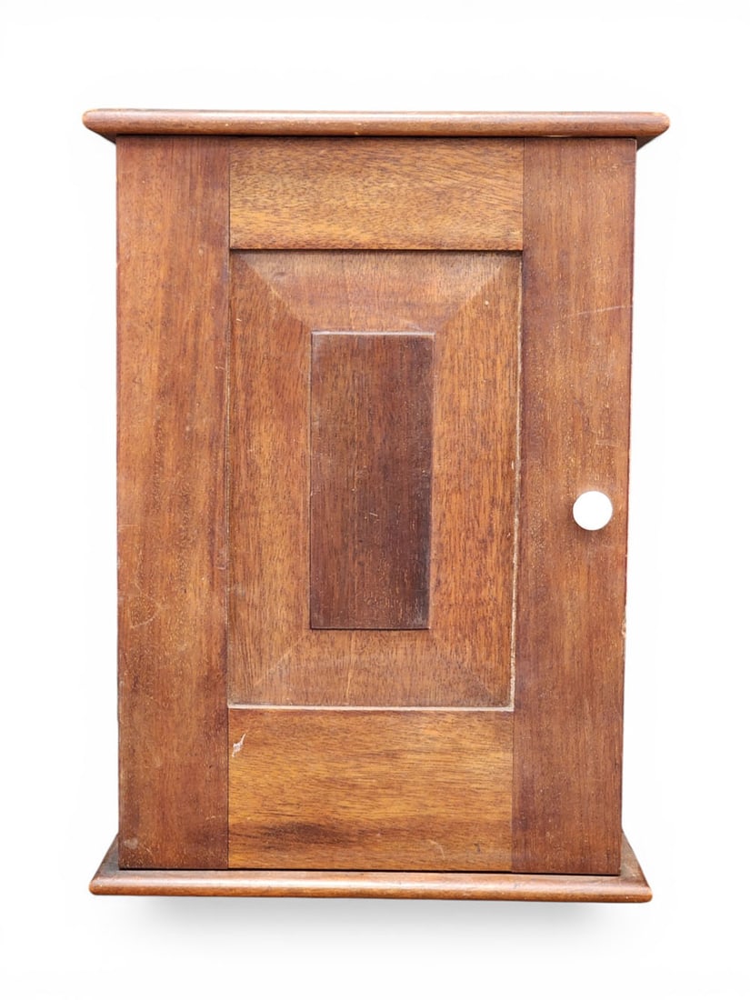 MINIATURE WARDROBE: American, 19th century, walnut and pine. Raised panel door. 13.25" high, 10" wide, 6" deep. Provenance: an Ohio collection. NOTE: We are happy to answer questions and take additional photos of lots