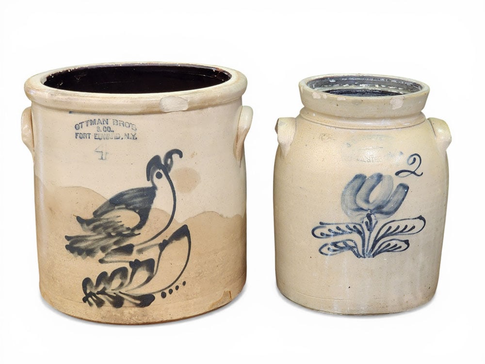 TWO DECORATED NEW YORK STONEWARE CROCKS: 3rd quarter-19th century. Includes a 2-gallon John Burger, Rochester jar with cobalt tulip, 11.5" high; and a 4-gallon Ottman Brothers, Ford Edward crock with cobalt bird, 11.5" high. Provenance: Coll