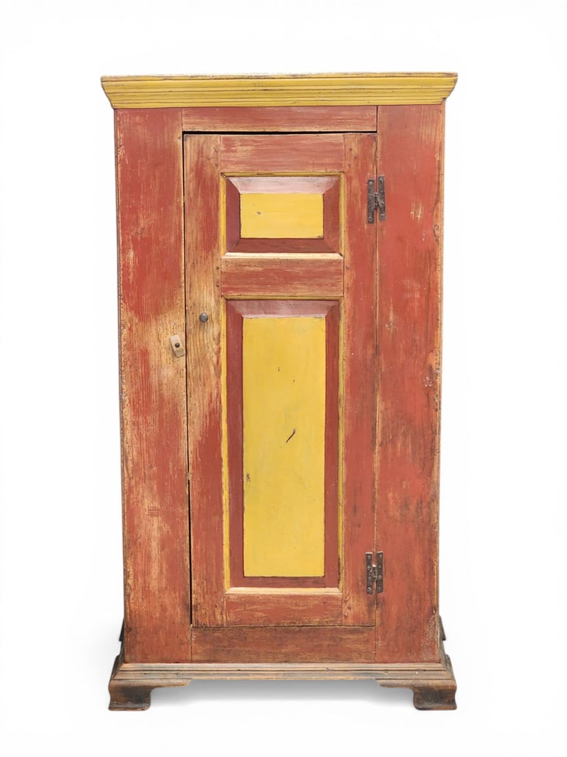 DIMINUTIVE DECORATED CUPBOARD: American, 19th century, pine. Double raised-panel door, ogee bracket feet. Red and yellow paint. 61.5" high, 33" deep, and 18.5" deep. Provenance: Collection of Bob and Maxine Edwards, New Philadelphi