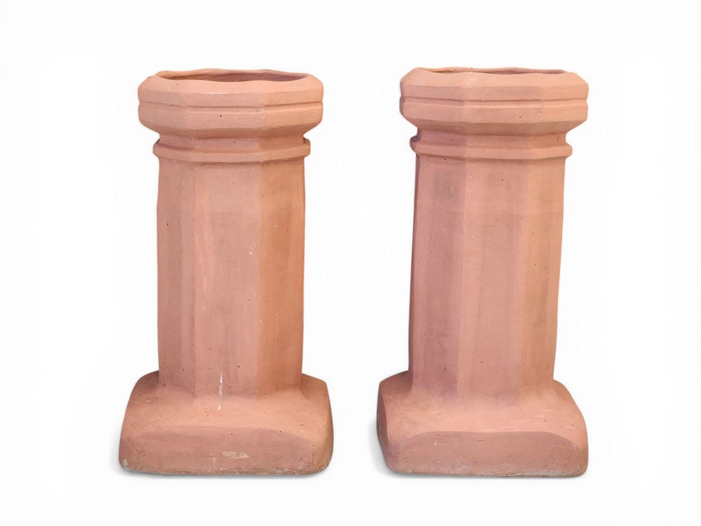PAIR OF CHIMNEY POTS / CAPS: Late 19th-early 20th century, terra cotta. 25" high. Provenance: a Pennsylvania collection. NOTE: We are happy to answer questions and take additional photos of lots prior to the auction (the sooner