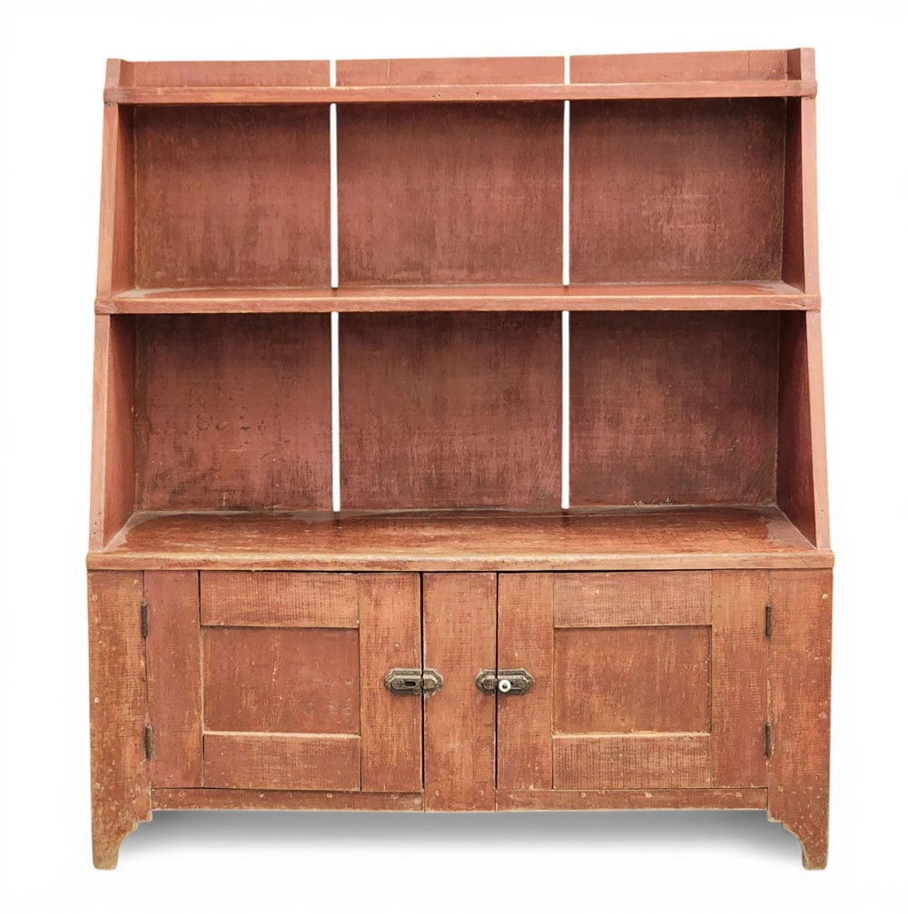 PAINTED BUCKET BENCH: American, mid-19th century, poplar. Slanted front with three shelves over two paneled doors. Original red paint. 48.75" high, 44.5" wide, 18" deep. Provenance: Collection of Bob and Maxine Edwards,