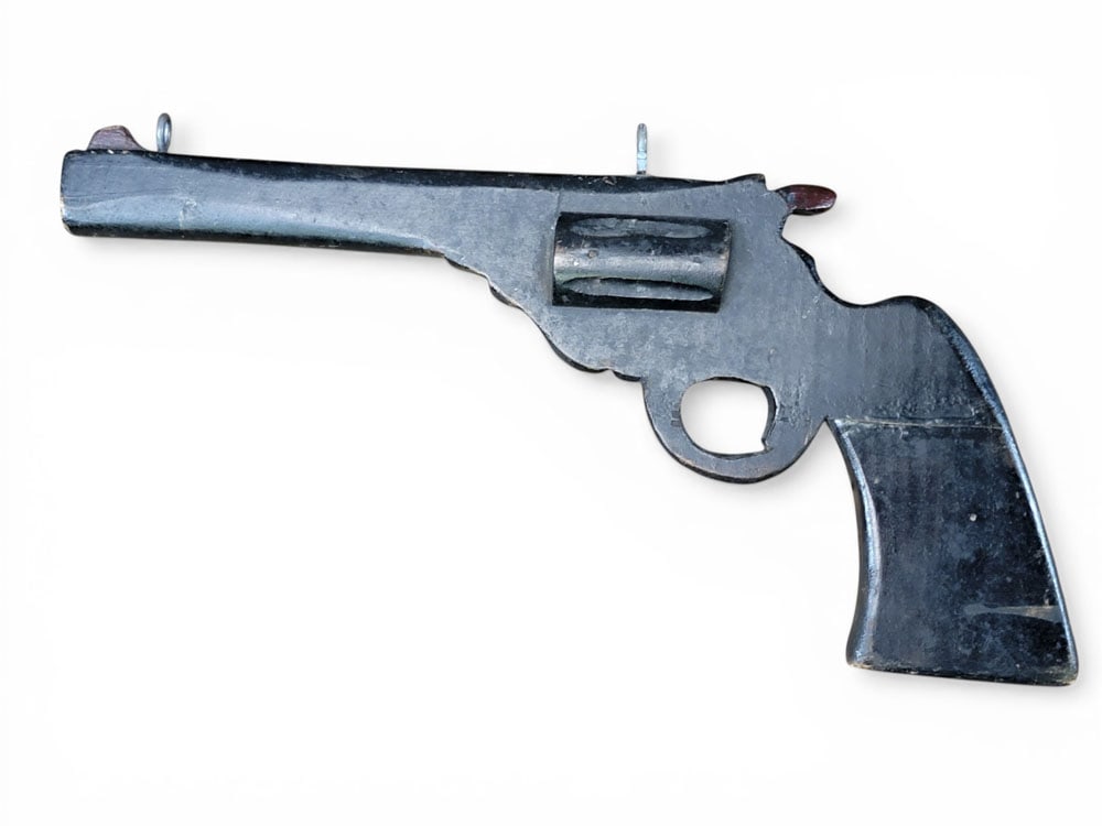 FIGURAL GUN SHOP TRADE SIGN: Madison, Wisconsin, mid-20th century. In the form of a revolver with original black paint. 16" long. Provenance: a Midwestern collection. NOTE: We are happy to answer questions and take additional pho