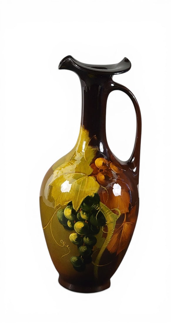 ROSEVILLE ROZANE EWER: Roseville, Ohio, early 20th century. A baluster form ewer with a delicate handle and a wavy rim, with floral decoration, Rozane line, signed by artist Walter Myers. 16" high. Provenance: Collection