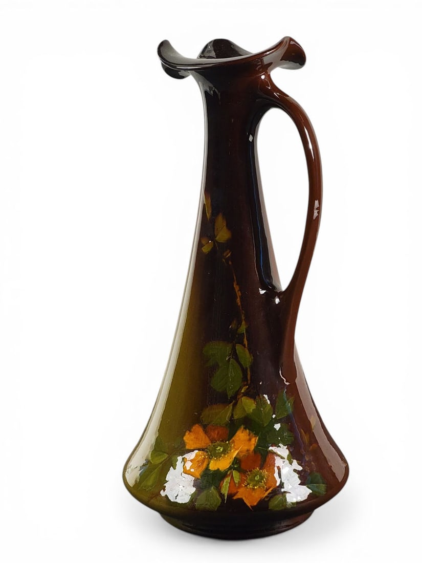 ROSEVILLE ROZANE EWER: Roseville, Ohio, early 20th century. An ewer of nearly conical form with a wavy rim and floral decoration, signed by artist Walter Myers. 16" high. Provenance: Collection of Ray and Eva Thomas, Zanesv