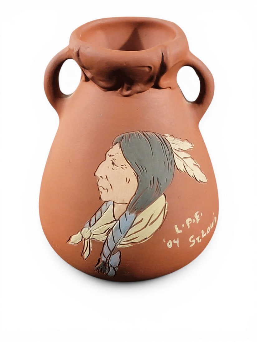 WELLER NATIVE AMERICAN PORTRAIT VASE: Zanesville, Ohio, 1904. A double-handled vase with a sgraffito profile portrait of a Native American, unmarked but similar to the second Dickens Ware line, marked LPE for Louisiana Purchase