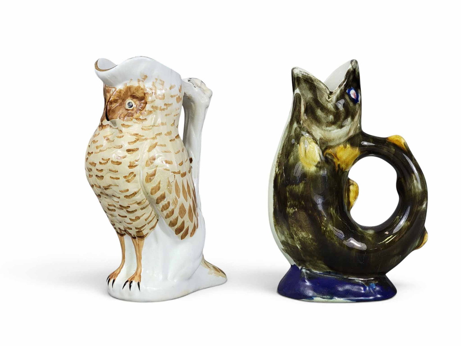 TWO OHIO FIGURAL POTTERY PITCHERS: Morley and Comapny, Wellsville, Ohio, late 19th century. Includes an owl, 8.25" high; together with a majolica fish, 8" high. Provenance: an Ohio collection. NOTE: We are happy to answer questions and