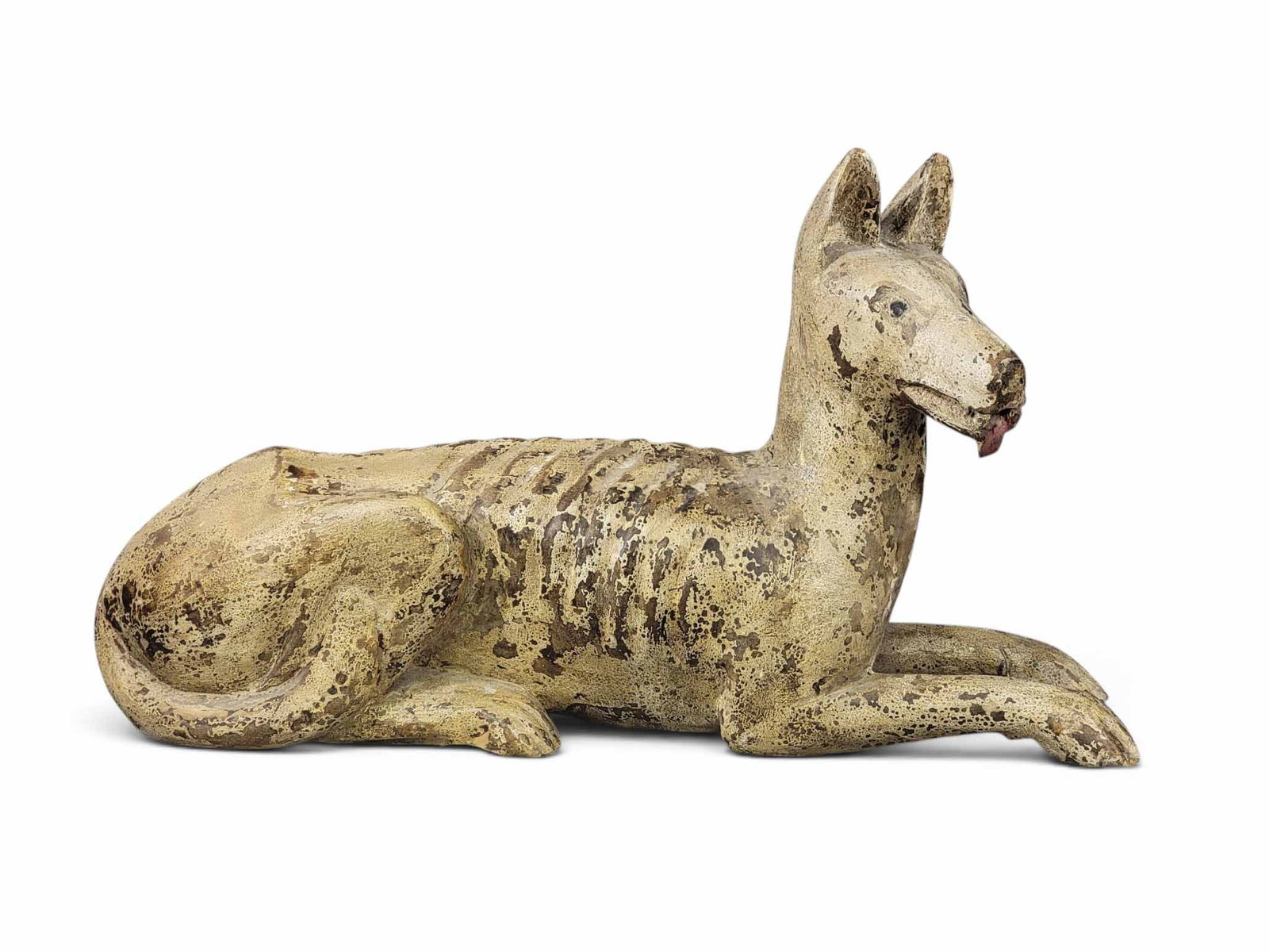 CARVED AND PAINTED DOG: American, late 19th century, pine. Life-size dog, well carved, with a lolling tongue, and with its original buff-colored paint.30" long. Provenance: an Ohio collection. NOTE: We are happy to answer