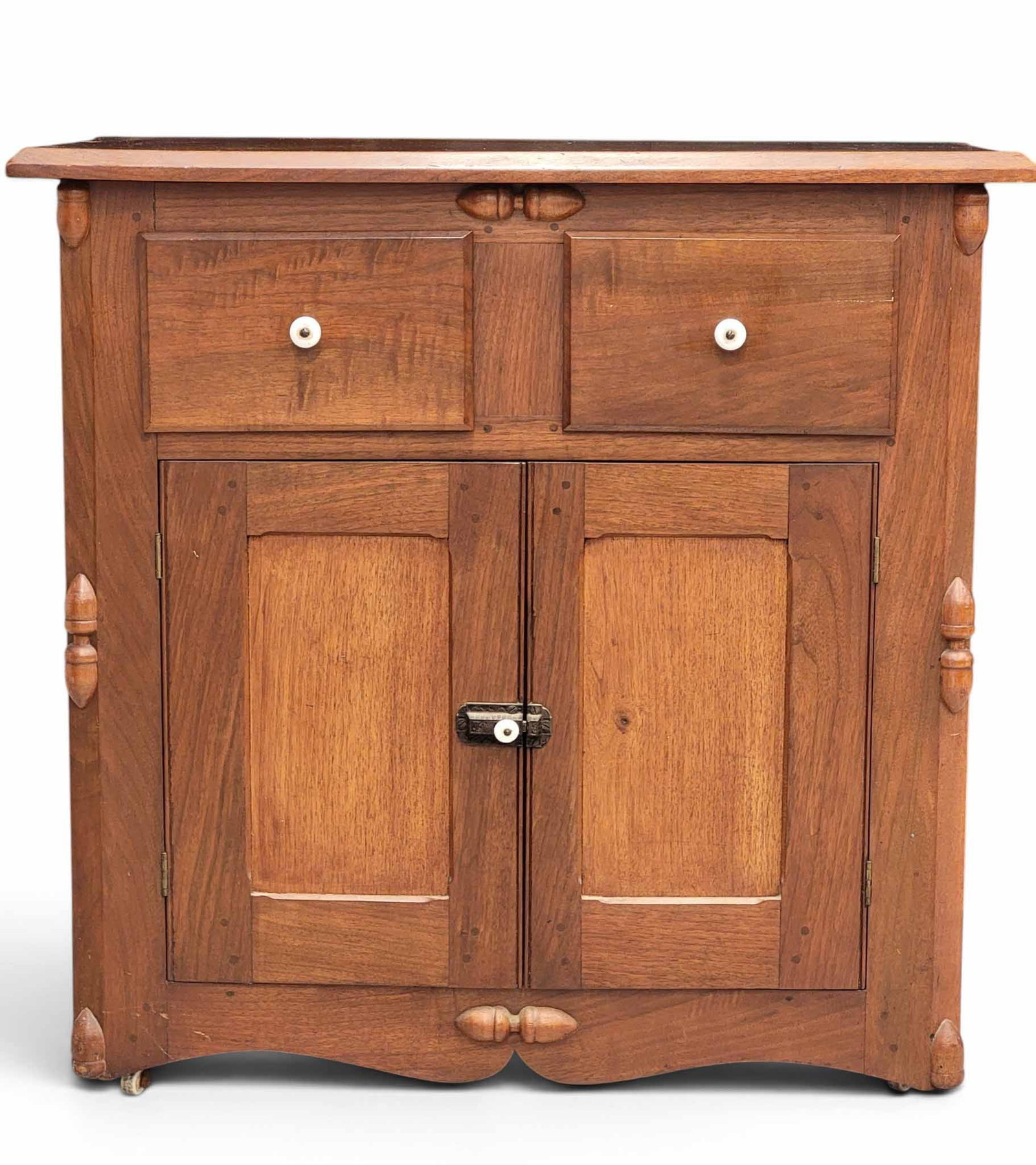ZOAR, OHIO WASHSTAND: Late 19th century, walnut and poplar. Two drawers over two doors, and with applied ornaments including molded diamonds on the sides. 33" high, 34" wide, 19" deep. NOTE: We are happy to answer