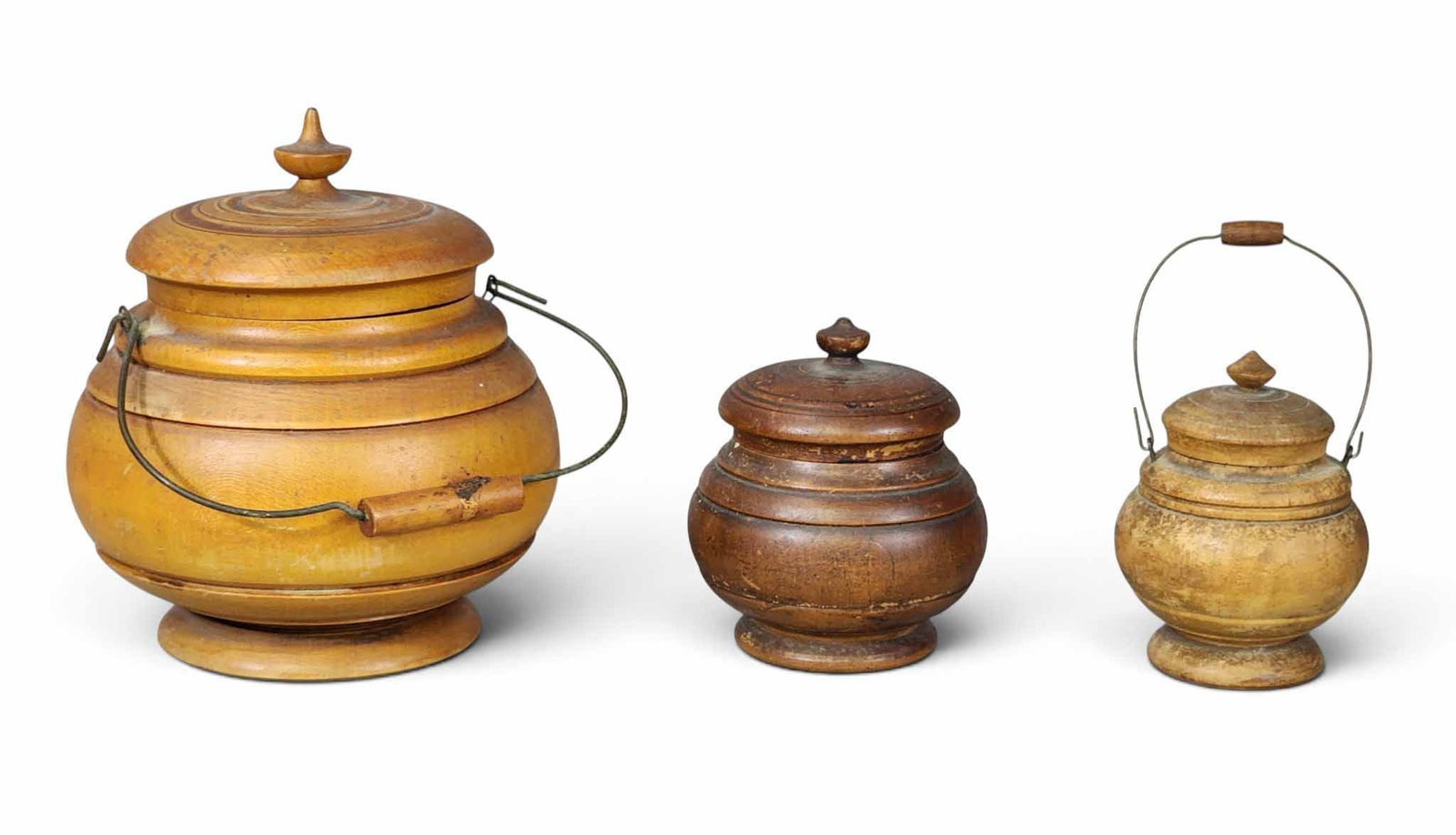 THREE PEASEWARE JARS: Please/Brown family, Concord Township, Lake County, Ohio, late 19th century, maple. Large and small with handles, medium without, all with old/original finish. 5.5", 4", and 3.5" high. Provenance: an 
