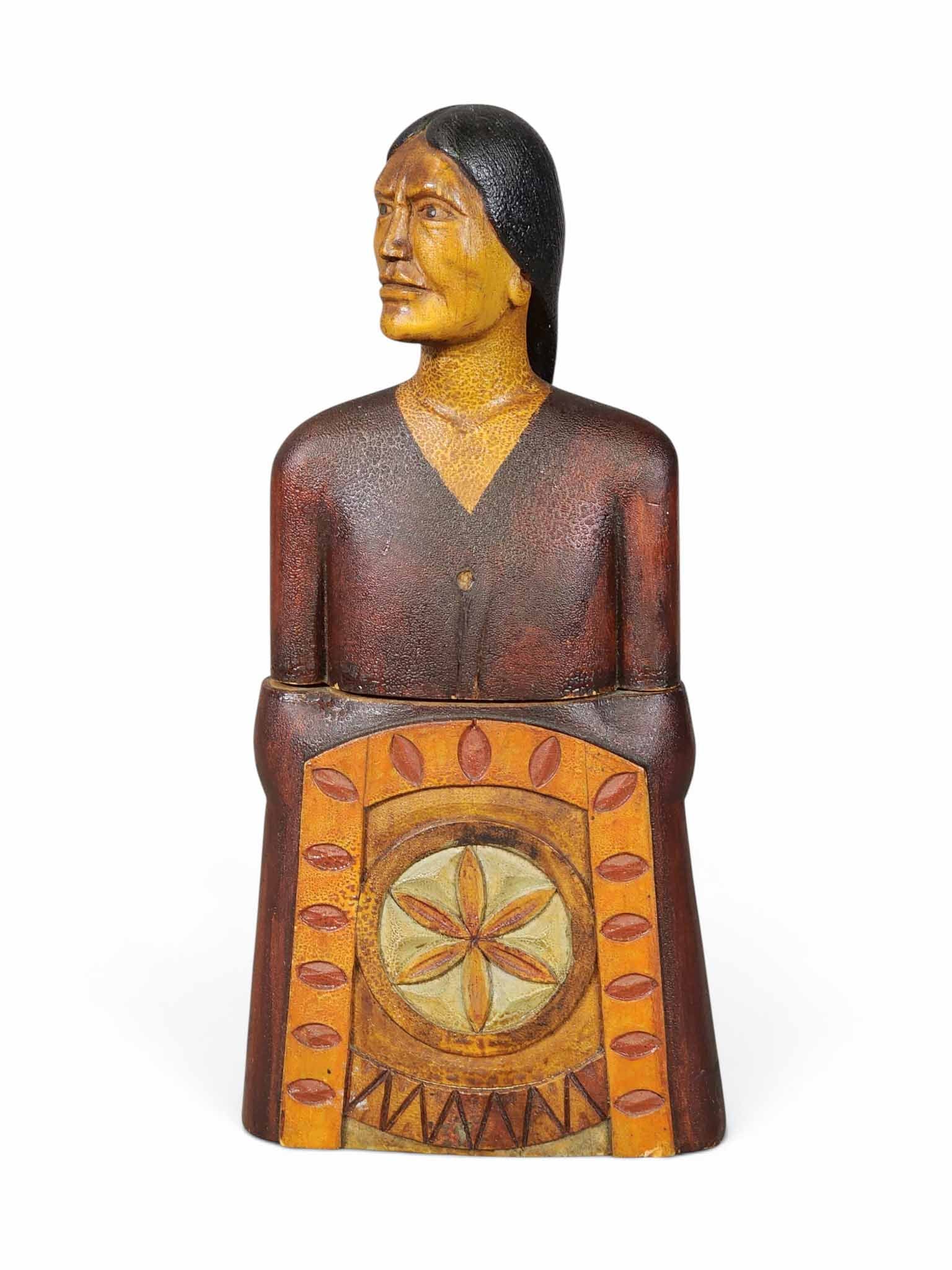 FOLK ART NATIVE AMERICAN BANK: Signed Ben Nelson and dated October 1910. Carved box that separates at the middle, in the form of a Native American carved base. Retains its original polychrome paint decoration with exceptional