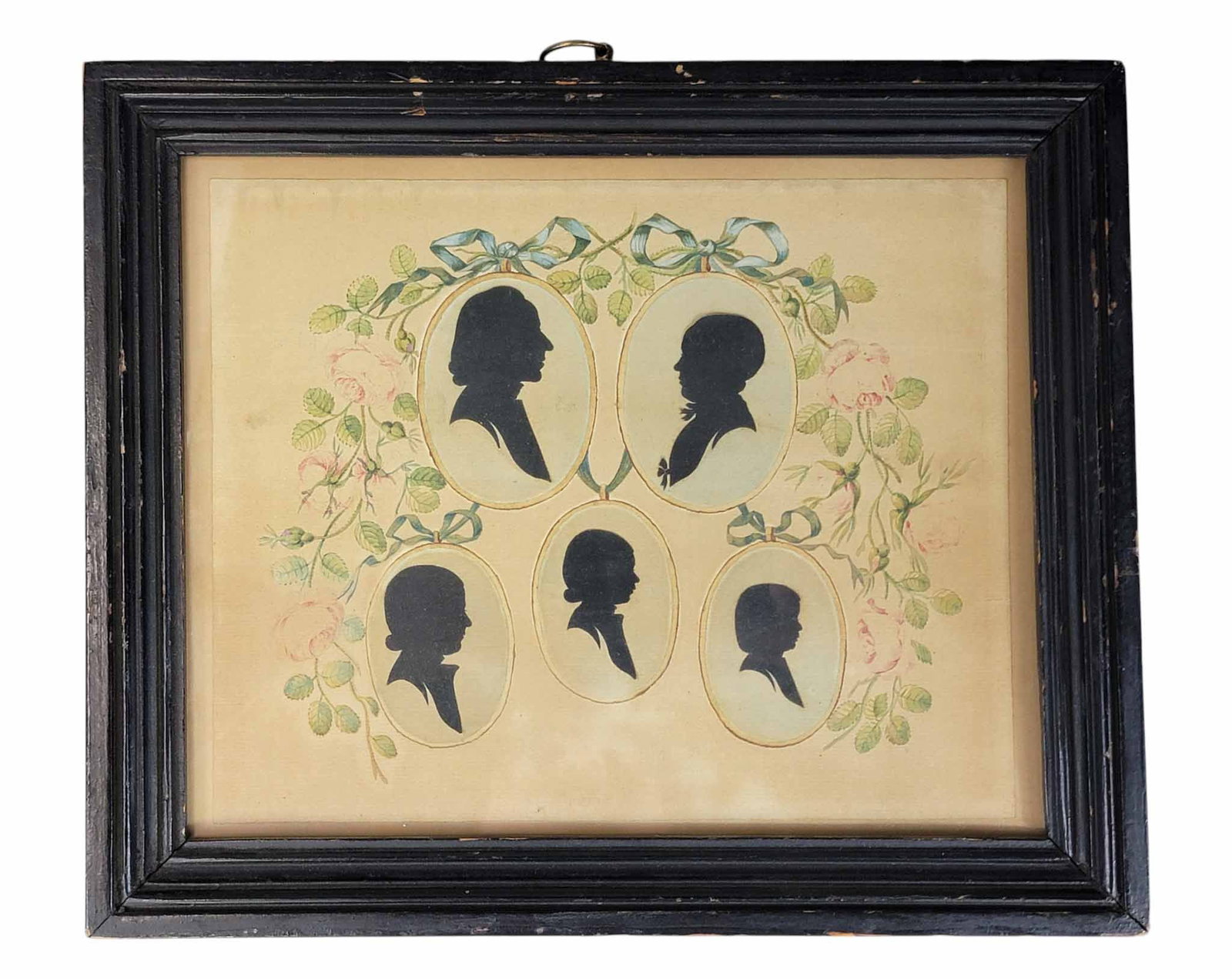 FAMILY GROUP OF SILHOUETTES: American, early 19th century, watercolor and wove paper. Five members of a family, all hollow-cut, and mounted against a flower and ribbon surround. In a period frame. 10.75" high, 12.75" wide