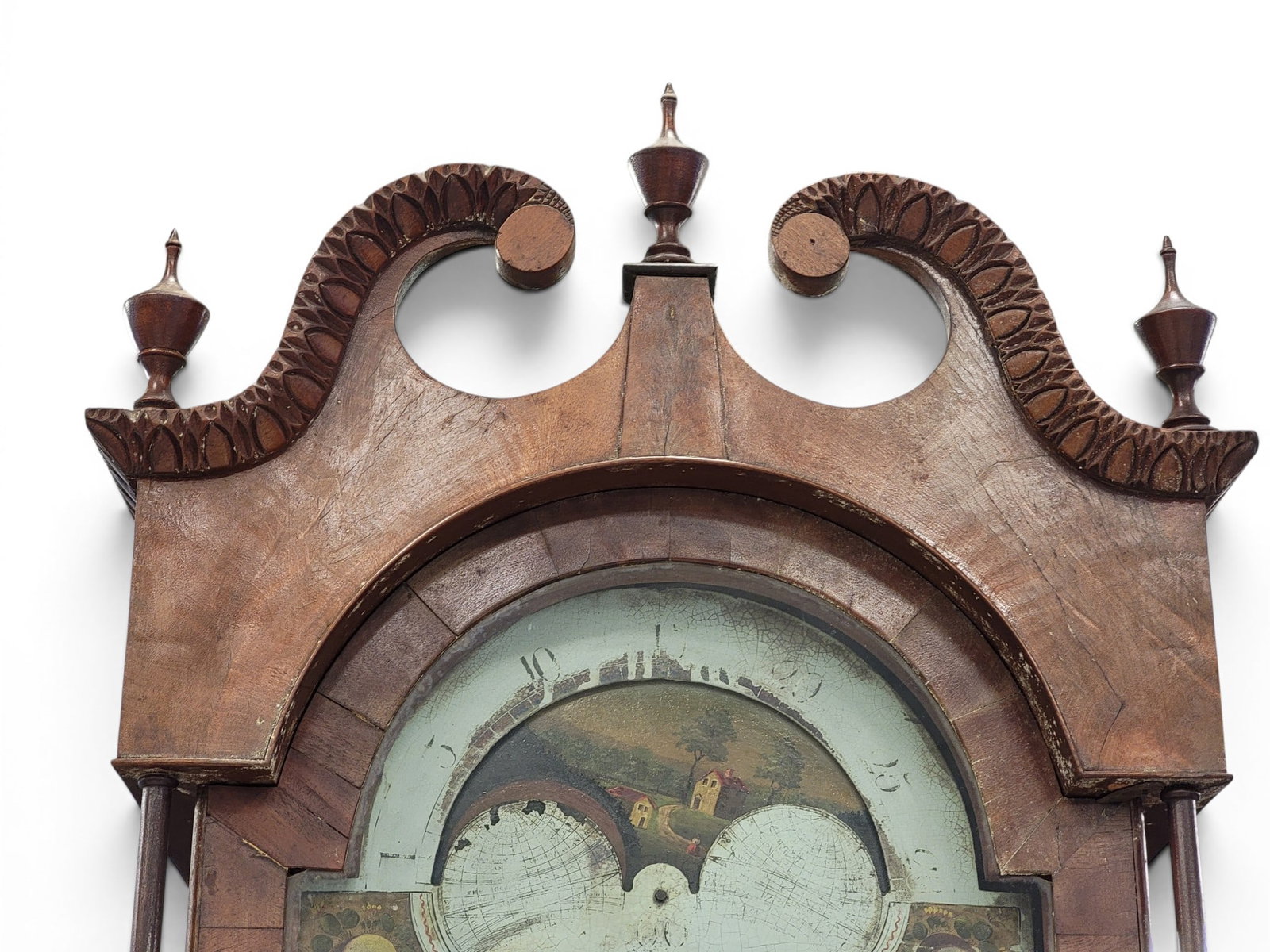 CLASSICAL TALL CASE CLOCK: Ohio River Valley, possibly Pittsburgh or Cincinnati, c. 1825, cherry and mahogany. Carved broken-arch pediment over a waist with figured veneer door flanked by columns, on a base with crotch veneer