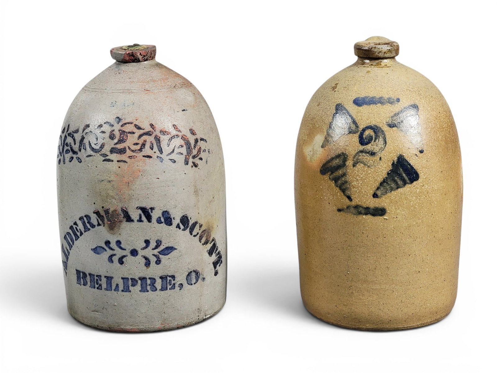 TWO OHIO STONEWARE JUGS: Includes a Muskingum County two-gallon jug with cobalt tornadoes, 14" high; together with a decorated two-gallon jug by Alderman and Scott of Belpre, 14" high. Justus Alderman (1837-1888) was born in 