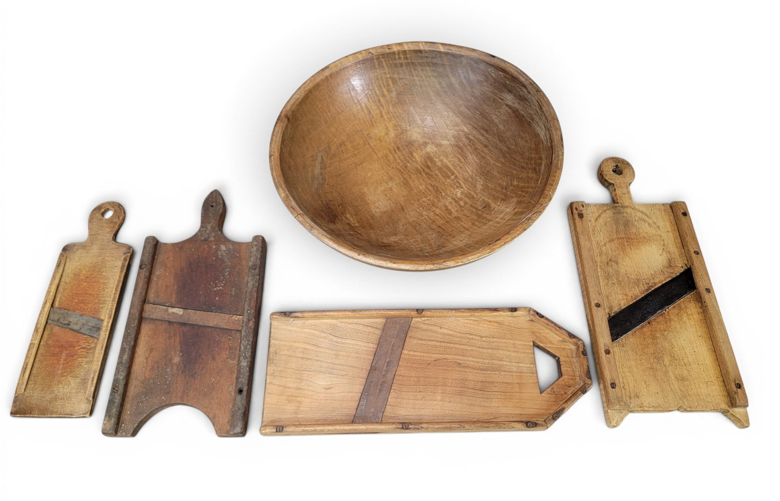WOODEN BOWL AND GROUP OF SLAW CUTTERS: American, 19th century. Includes a curly maple 20.5" bowl; together with four slaw cutters, 15" to 21" long. Provenance: an Ohio collection. NOTE: We are happy to answer questions and take additional