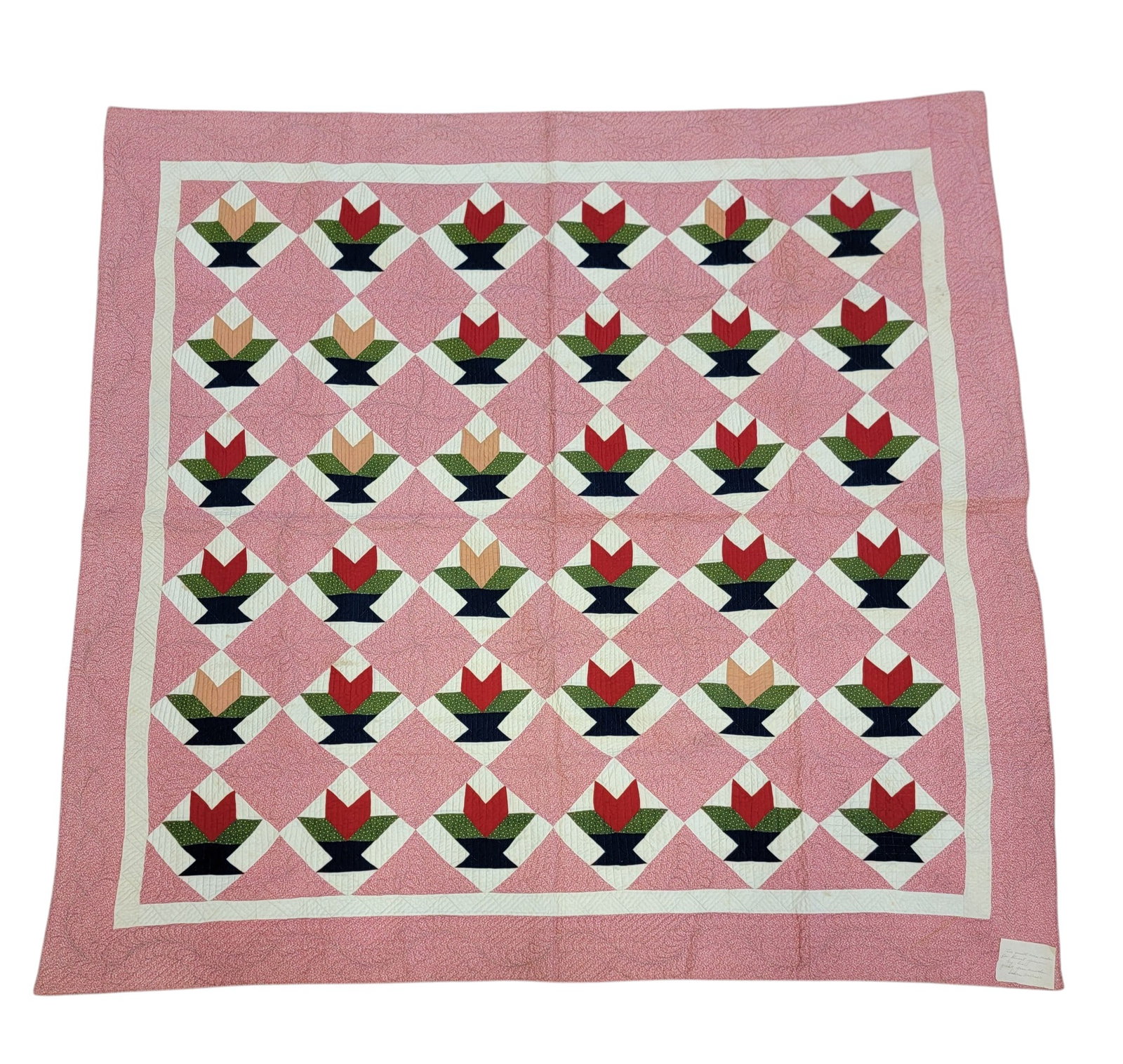 OHIO PIECED QUILT: Sabra Ward Outcalt, Morgan County, 1890s, cotton. Stylized floral pattern with printed red and white fabric, handsewn, including elaborate quilting. 78.75" by 76.5". Attached is an early note