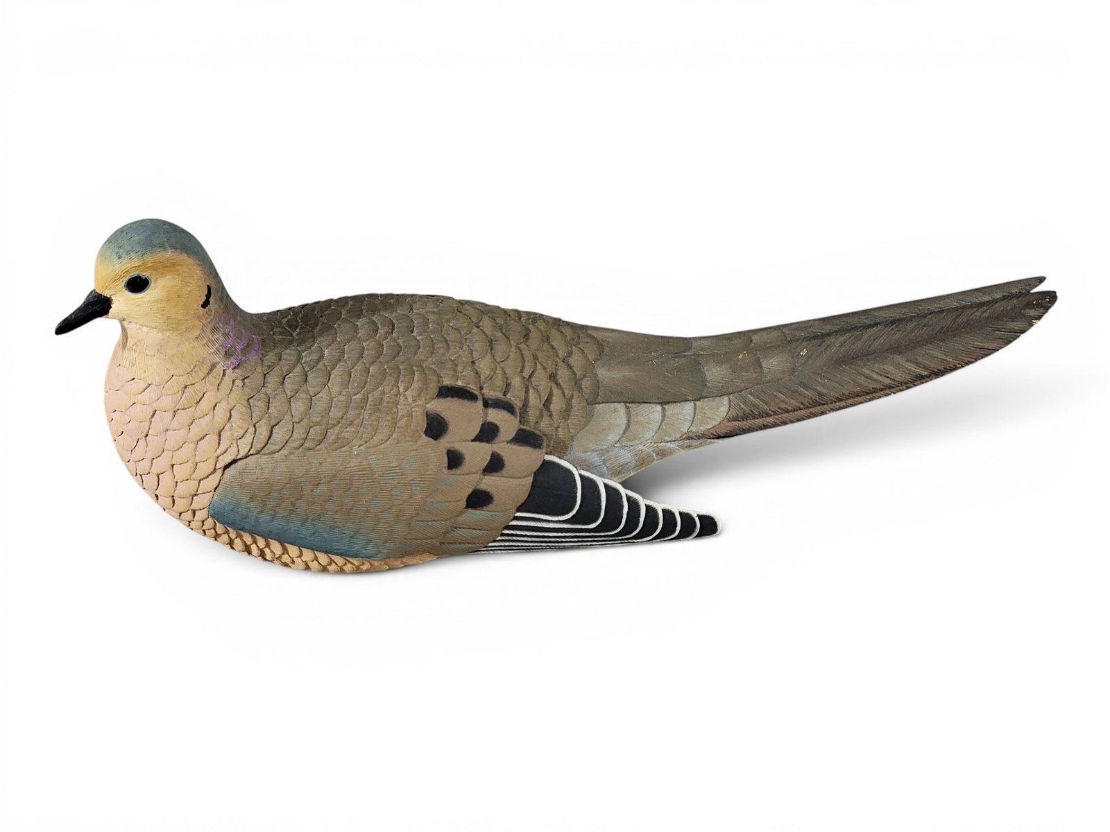 CARVED MOURNING DOVE BY WILLIAM HANEMANN (B. 1947): New Orleans, Louisiana, signed and dated 1976. Delicately carved feathers. 10" long. Provenance: an Ohio collection. NOTE: We are happy to answer questions and take additional photos of lots prior to