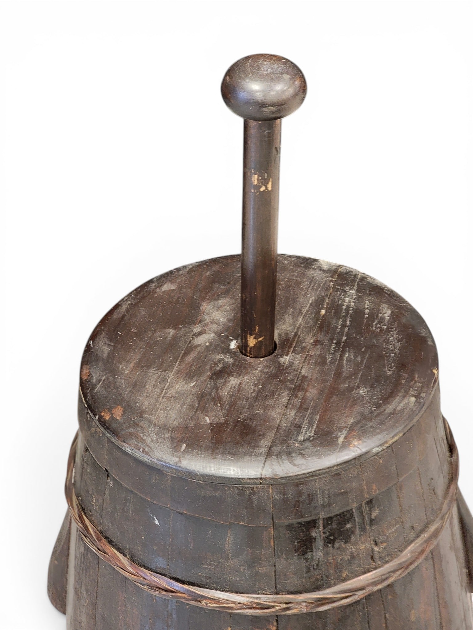 BUTTER CHURN: 19th century. Large size, stave-constructed, with woven bands. 42" high (including dasher). NOTE: We are happy to answer questions and take additional photos of lots prior to the auction (the sooner s
