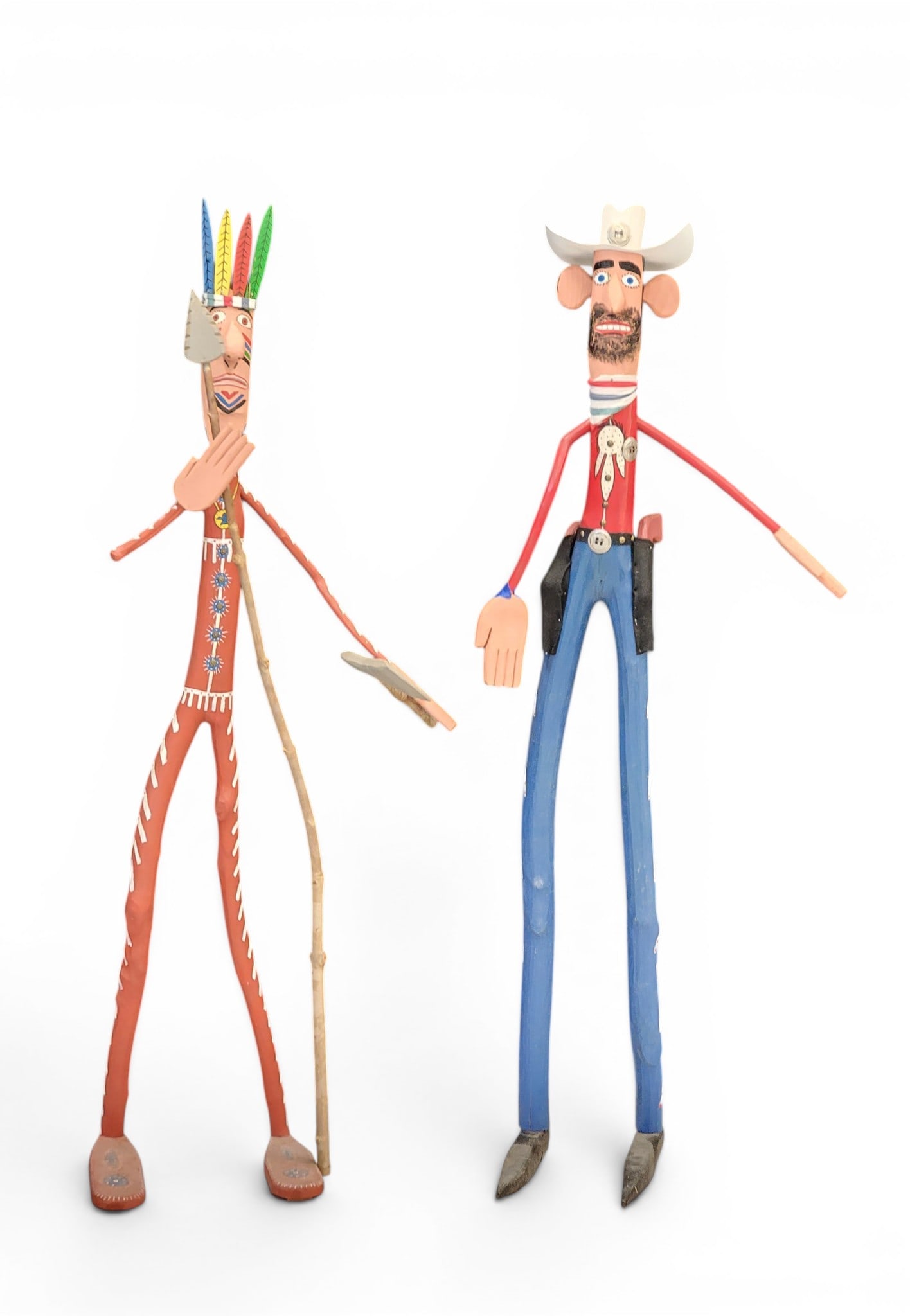 PAIR OF FOLK ART FIGURES BY HARRY JENNINGS (KENTUCKY, B. 1966): Signed on the underside of the feet. A cowboy and Native American, both cartoonish and brightly painted. Each about 63" high. NOTE: We are happy to answer questions and take additional photos of lots