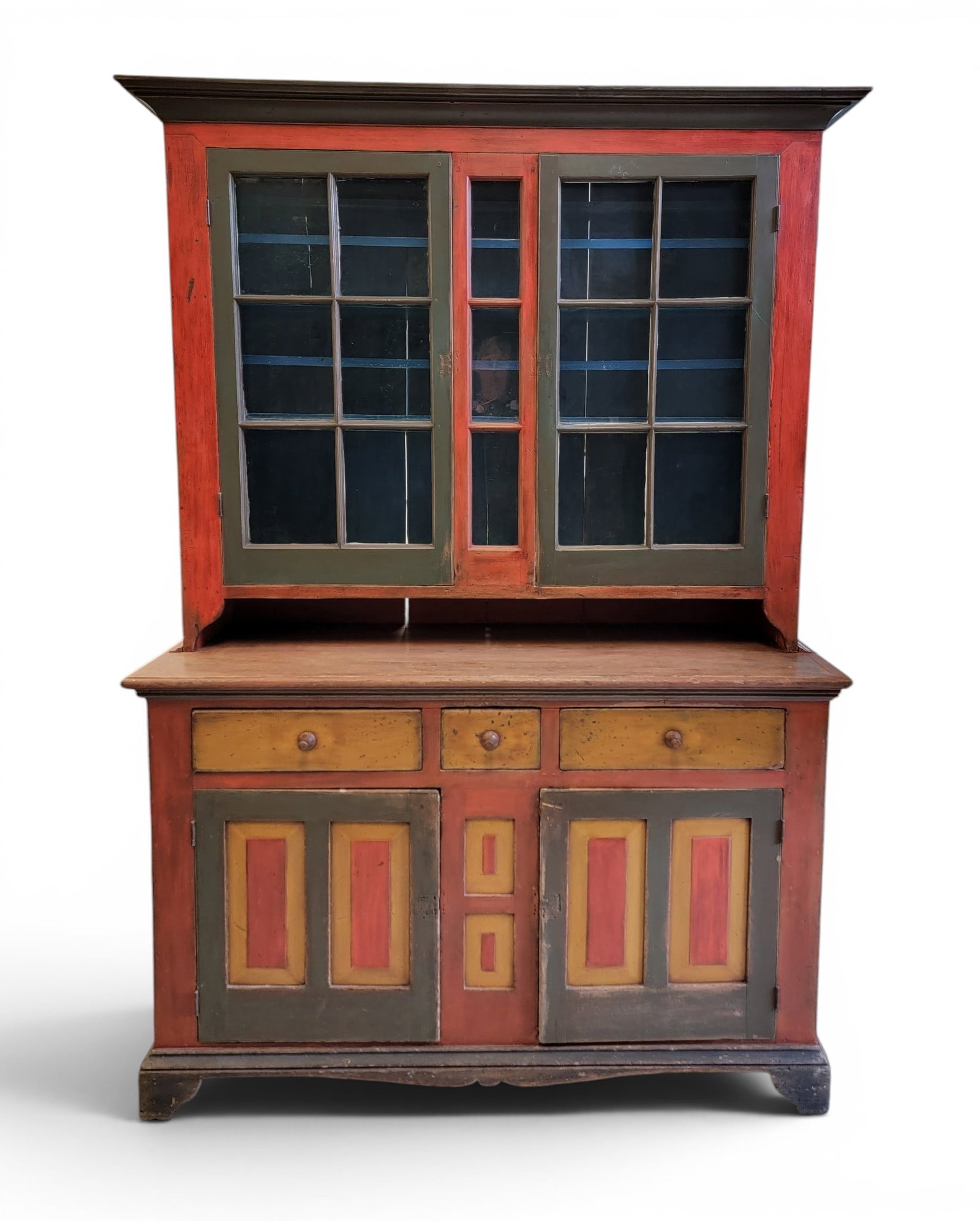 PAINTED STEP-BACK CUPBOARD: Pennsylvania, 2nd quarter-19th century, poplar. Two-piece construction, the upper section with two 6-pane doors and a central 3-pane panel, the lower section with three drawers over two double-panel