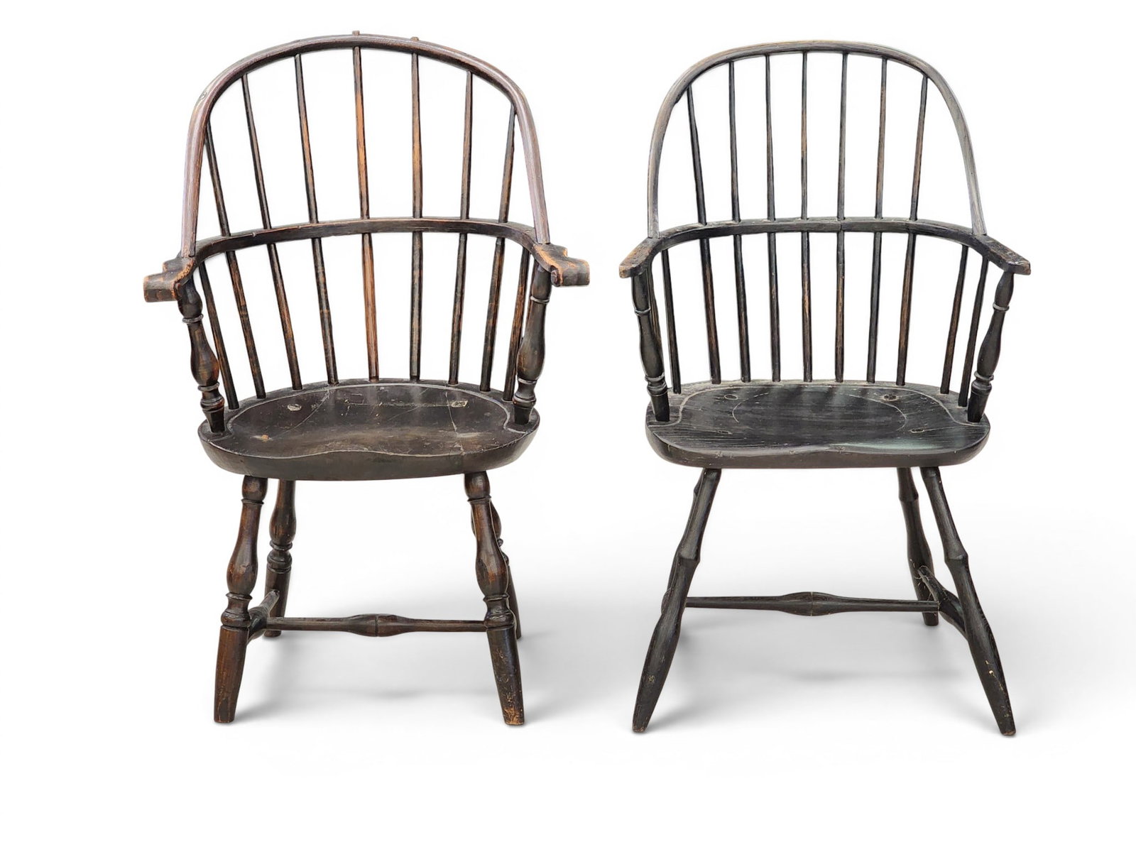 TWO WINDSOR ARMCHAIRS: American, late 18th century, mixed woods. Bowback windsors in old black paint. 38" and 37.5" high. Provenance: Collection of Bob and Maxine Edwards, New Philadelphia, Ohio. NOTE: We are happy to
