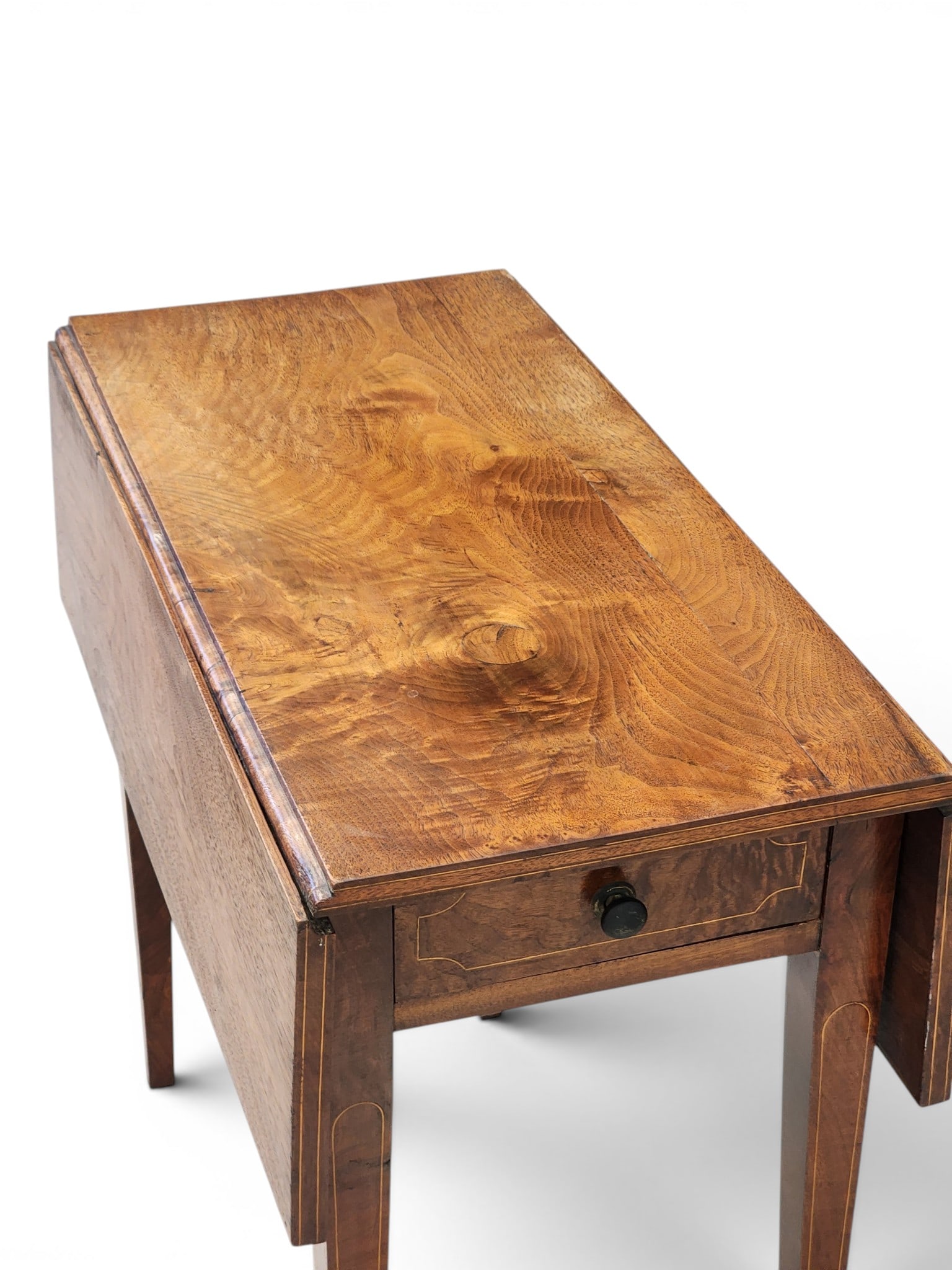 INLAID PEMBROKE TABLE: American, early 19th century, mahogany and poplar. Highly figured top over one drawer and tapered legs, with string inlay. 27" high, 28" wide, 30.25" deep (open), 14.75" deep (closed). Provenance: