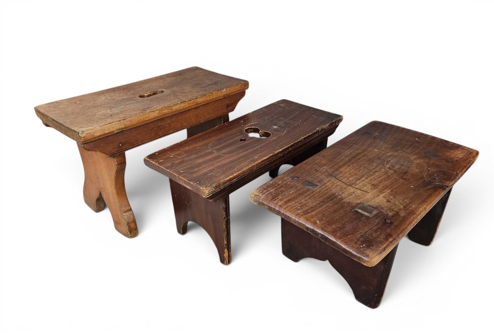THREE STOOLS: American, 19th century. Cherry, 19" long; pine, 19" long; and with original paint decoration including "CR", 19" long. Provenance: Collection of Bob and Maxine Edwards, New Philadelphia, Ohio. NOTE: W