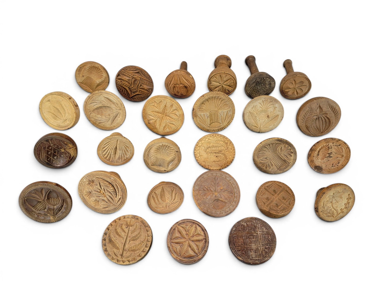 COLLECTION OF BUTTER MOLDS: American, 19th century. Large group, mostly plants and flowers, including thistles and acorns. Various sizes. Provenance: Collection of Bob and Maxine Edwards, New Philadelphia, Ohio. NOTE: We are
