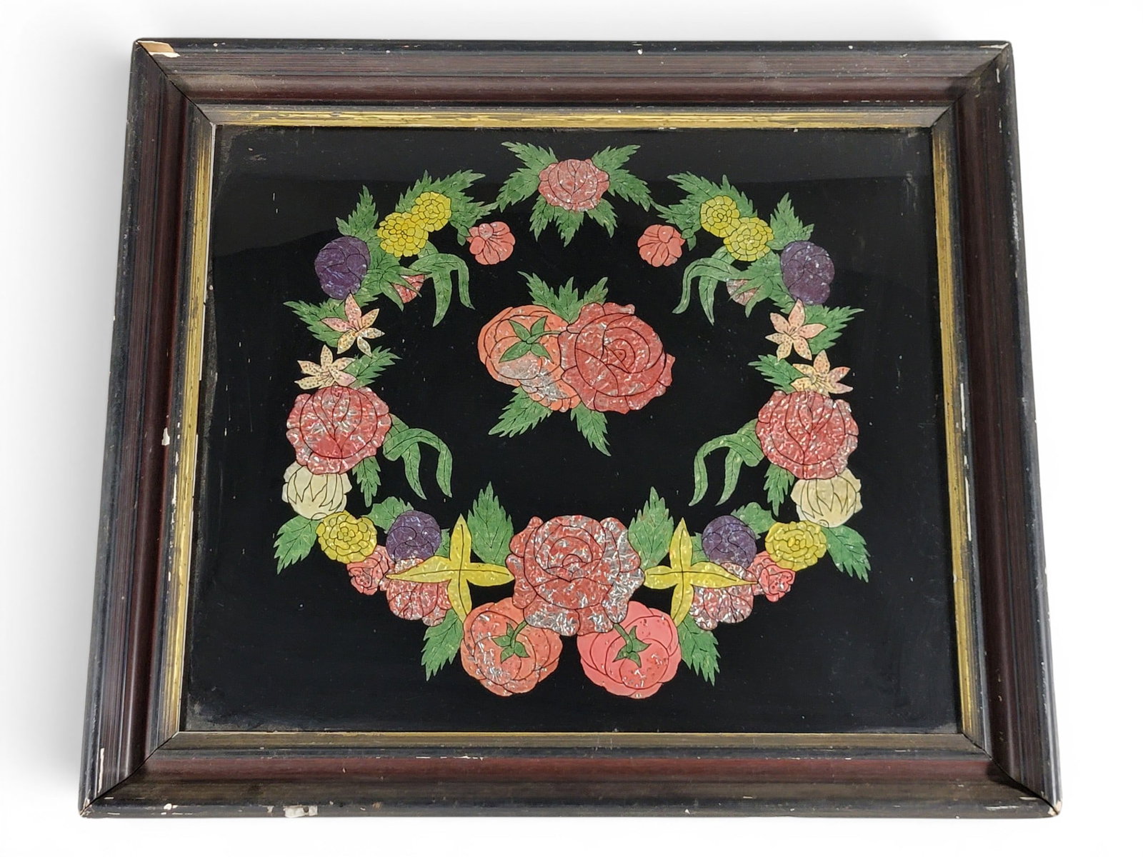 TINSEL PICTURE: American, late 19th century. Reverse-painted and foil-backed floral wreath in its original frame. 24.75" high, 28.75" wide (overall). Provenance: a Pennsylvania collection. NOTE: We are happy to